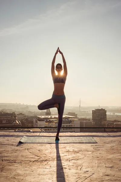 woman doing yoga on the rooftop